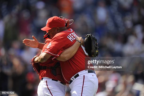 Livan Hernandez#61 and Ivan ROdriguez of the Washington Nationals celebrate a win after a baseball game against the Milwaukee Brewers on April17,...