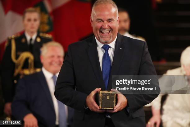 Todd Smith, Minister of Government and Consumer Services, and Government House Leader holds the Ontario seal. Doug Ford is sworn in as the 26th...
