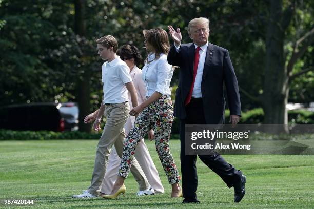 President Donald Trump , first lady Melania Trump , their son Barron Trump , and mother-in-law Amalija Knavs walk on the South Lawn of the White...