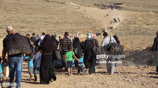 Syrians wait at the border areas near Jordan after they fled from the ongoing military operations by Bashar al-Assad regime and its allies in Syrias...