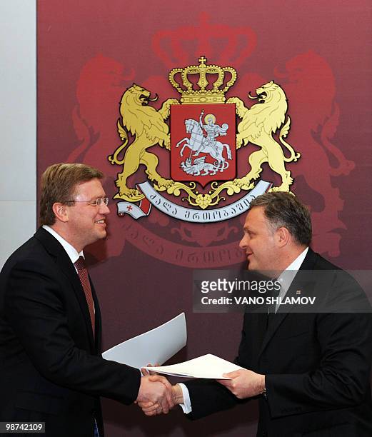 Georgia's Vice Prime Minister Giorgi Baramidze and the EU Enlargement and European Neighbourhood Policy Commissionner Stefan Fule shake hands after...