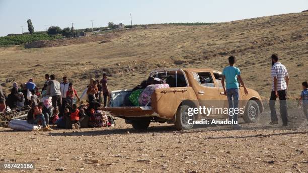 Car covered with mud is seen as Syrians wait at the border areas near Jordan after they fled from the ongoing military operations by Bashar al-Assad...