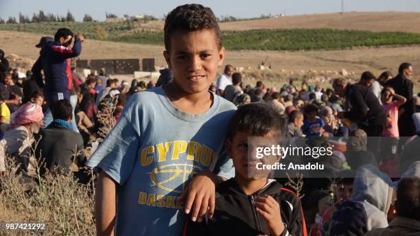 Syrians wait at the border areas near Jordan after they fled from the ongoing military operations by Bashar al-Assad regime and its allies in Syrias...