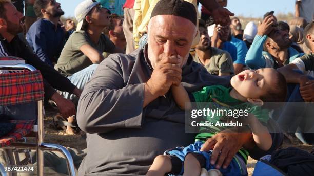 Syrians wait at the border areas near Jordan after they fled from the ongoing military operations by Bashar al-Assad regime and its allies in Syrias...