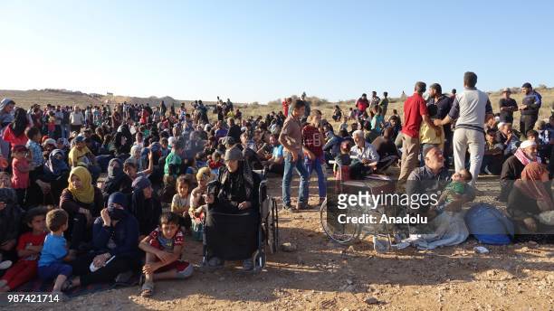 Syrians wait at the border areas near Jordan after they fled from the ongoing military operations by Bashar al-Assad regime and its allies in Syrias...