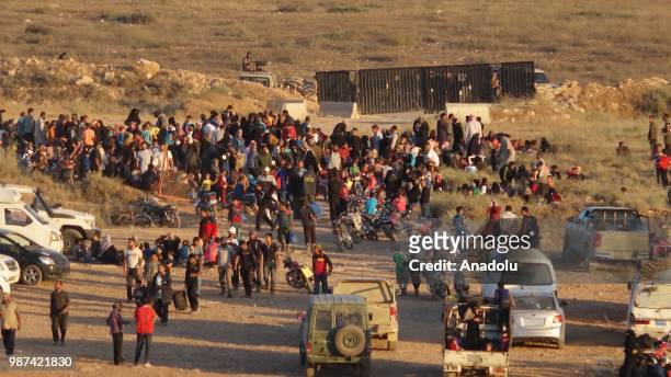 Syrians wait at the border areas near Jordan after they fled from the ongoing military operations by Bashar al-Assad regime and its allies in Syrias...