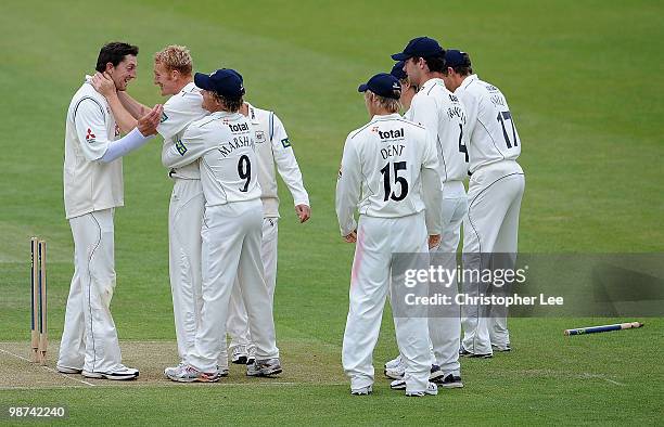 Jon Lewis congratulates team mate Steve Kirby of Gloucestershire after he takes the wicket of John Simpson of Middlesex during Day Three of the LV...