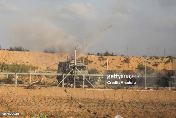 Israeli forces fire tear gas along the border between the Gaza Strip and Israel on the 14th week of right of return march in Gaza City, Gaza on June...