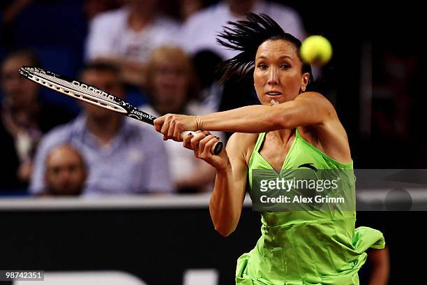Jelena Jankovic of Serbia plays a backhand during her second round match against Tsvetana Pironkova of Bulgaria at day four of the WTA Porsche Tennis...
