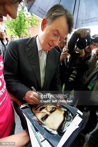 Business Secretary, Peter Mandelson signs a photograph of Prime Minister Gordon Brown during a visit to The University of Birmingham on April 29,...