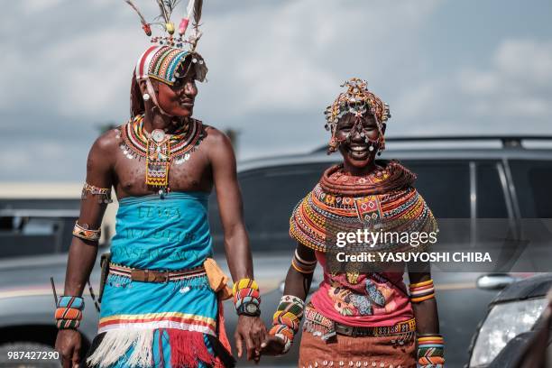 Samburu tribal couple walk hand in hand during the 11th Marsabit Lake Turkana Culture Festival in Loiyangalani near Lake Turkana, northern Kenya, on...