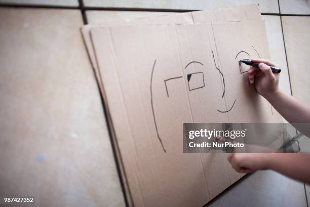 Man draw Emoji face during protest against ACTA 2.0 in Warsaw in Warsaw on June 29, 2018.