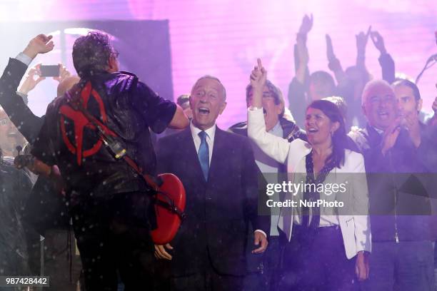 Portugal's President Marcelo Rebelo de Sousa and Portugal's Prime Minister Antonio Costa sing on stage with Portuguese rock band Xutos &amp; Pontapes...