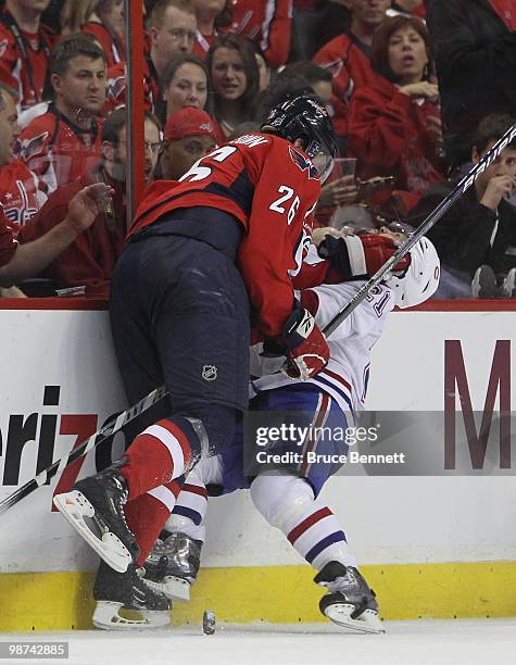 Brian Gionta of the Montreal Canadiens is hit by Shaone Morrisonn of the Washington Capitals in Game Seven of the Eastern Conference Quarterfinals...