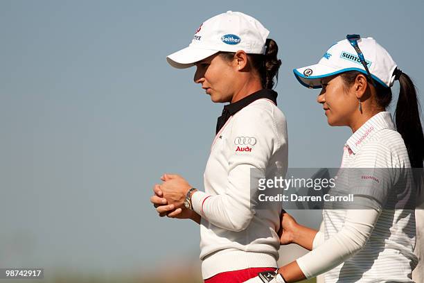 Lorena Ochoa of Mexico walks to the tee with Ai Miyazato of Japan during the first round of the Tres Marias Championship at the Tres Marias Country...