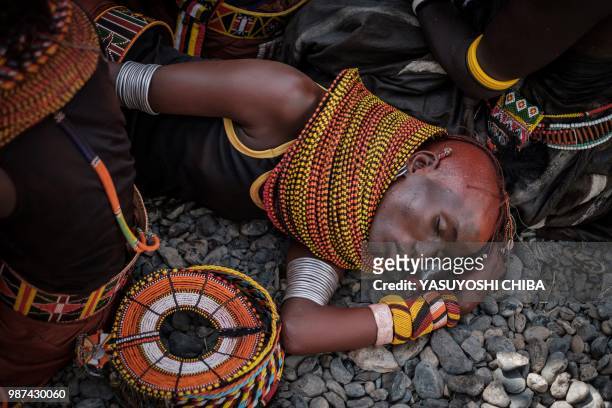 Dancer of the Turkana tribe rests in the shade after their performance during the 11th Marsabit Lake Turkana Culture Festival in Loiyangalani near...