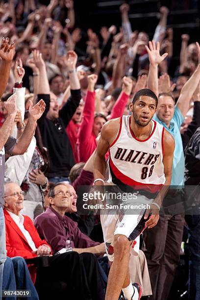 Fans celebrate after a play as Nicolas Batum of the Portland Trail Blazers moves up court in Game Four of the Western Conference Quarterfinals...