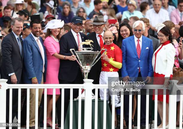 Owner Kenny Trout and Jockey Mike Smith pose with the Triple Crown Trophy after the 150th running of the Belmont Stakes at Belmont Park on June 9,...