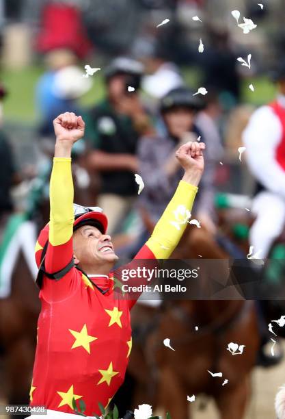 Jockey Mike Smith celebrates atop of Justify during the 150th running of the Belmont Stakes at Belmont Park on June 9, 2018 in Elmont, New York....