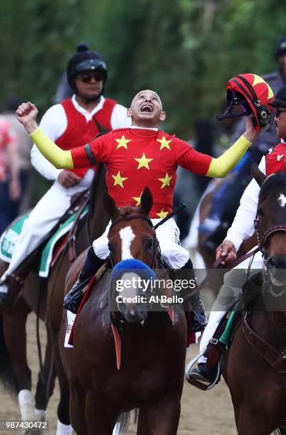 Jockey Mike Smith celebrates atop of Justify during the 150th running of the Belmont Stakes at Belmont Park on June 9, 2018 in Elmont, New York....