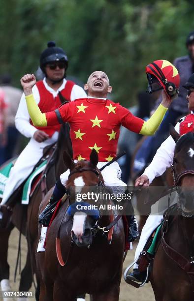 Jockey Mike Smith celebrates atop of Justify during the 150th running of the Belmont Stakes at Belmont Park on June 9, 2018 in Elmont, New York....