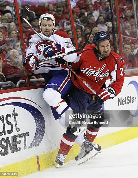 Josh Gorges of the Montreal Canadiens is hit into the boards by Scott Walker of the Washington Capitals in Game Seven of the Eastern Conference...