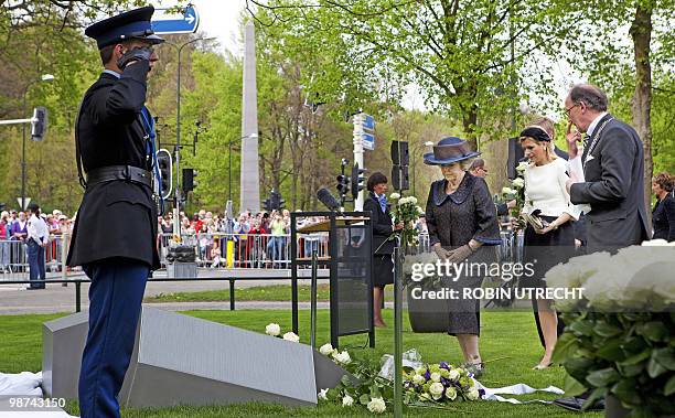 Dutch Queen Beatrix unveils on April 29, 2010 in Apeldoorn the monument of remebrance for the victims of the incident on Queensday last year,...