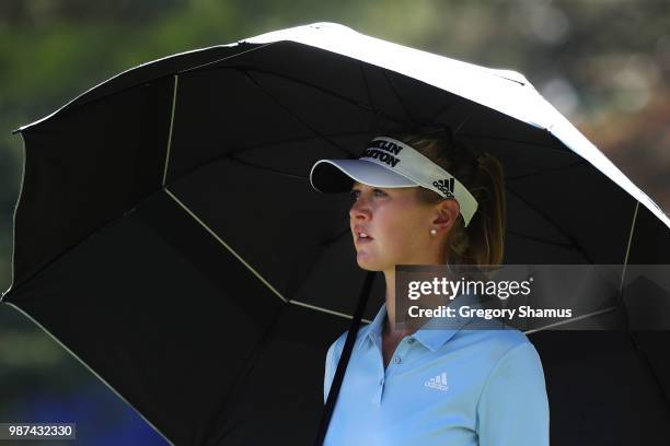Jessica Korda waits under a umbrella on the 16th green during the second round of the 2018 KPMG PGA Championship at Kemper Lakes Golf Club on June...