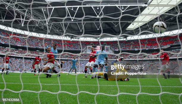 Joleon Lescott of Manchester City scores the first goal past David De Gea of Mancheseter United during the FA Community Shield match between...