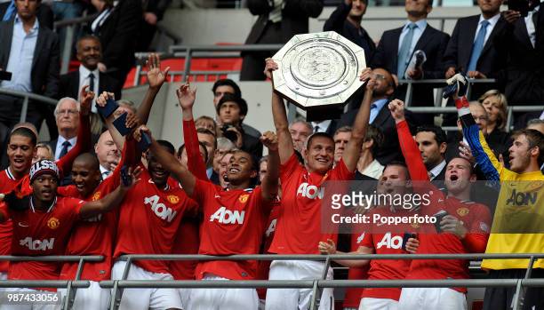 Nemanja Vidic of Manchester United and his teammates celebrate with the trophy following the FA Community Shield match between Manchester City and...