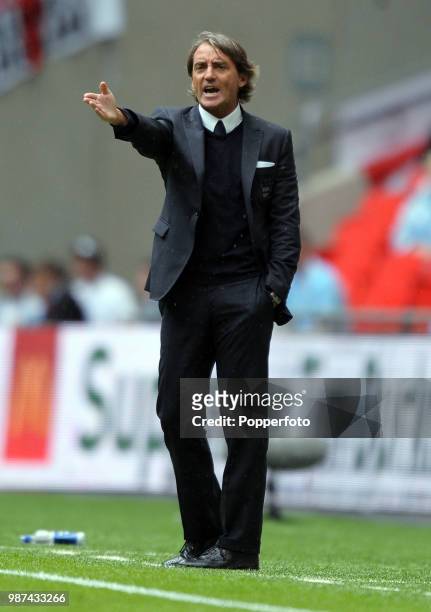 Manchester Ccity manager Roberto Mancini giving instructions from the touchline during the FA Community Shield match between Manchester City and...