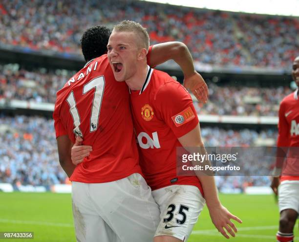 Tom Cleverley of Manchester United celebrates with teammate and third goal-scorer Nani during the FA Community Shield match between Manchester City...