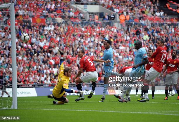 Joleon Lescott of Manchester City scores the first goal past David De Gea of Manchester United during the FA Community Shield match between...