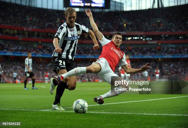 Thomas Vermaelen of Arsenal and Joel Ekstrand of Udinese in action during the UEFA Champions League play-off first leg match between Arsenal and...