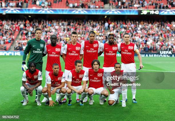 The Arsenal football team prior to the UEFA Champions League play-off first leg match between Arsenal and Udinese at the Emirates Stadium in London...
