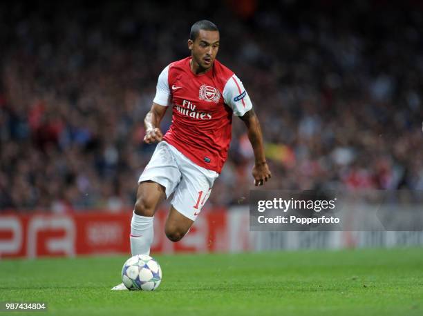 Theo Walcott of Arsenal in action during the UEFA Champions League play-off first leg match between Arsenal and Udinese at the Emirates Stadium in...