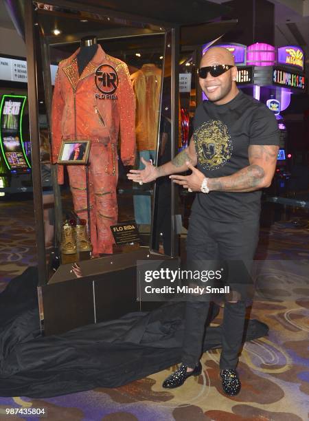 Rapper Flo Rida poses next his memorabilia case during the dedication at the Hard Rock Hotel & Casino on June 29, 2018 in Las Vegas, Nevada.