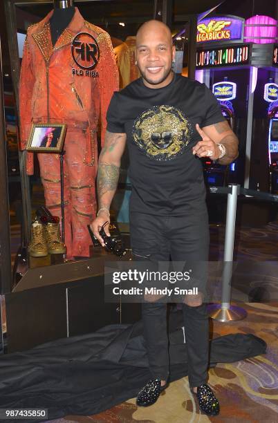 Rapper Flo Rida poses next to his memorabilia case during the dedication at the Hard Rock Hotel & Casino on June 29, 2018 in Las Vegas, Nevada.