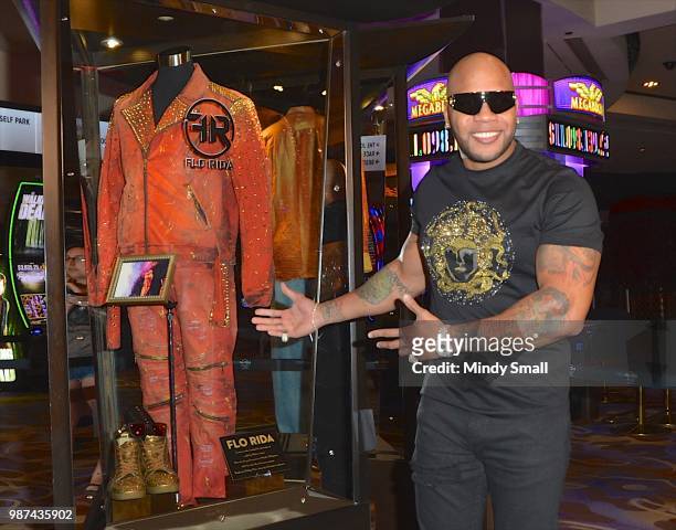 Rapper Flo Rida poses next to his memorabilia case during the dedication at the Hard Rock Hotel & Casino on June 29, 2018 in Las Vegas, Nevada.