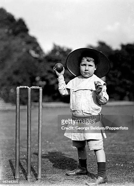 William Edgar Grace, the grandson of Dr WG Grace posing with a cricket ball, circa 1905.