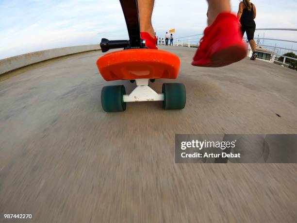 rolling with longboard in the city boardwalk from creative point o view. - mataro stock pictures, royalty-free photos & images