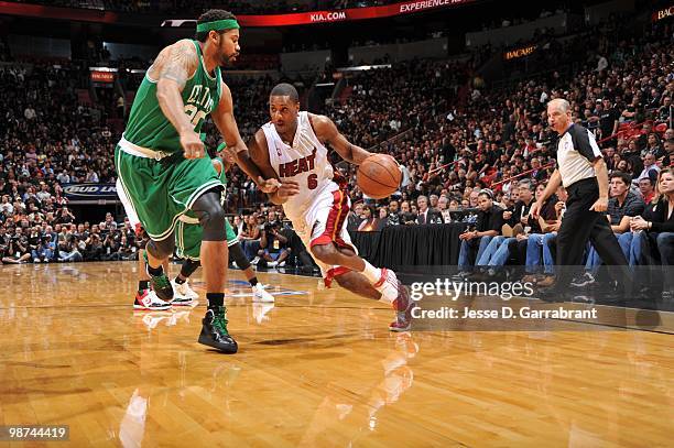 Mario Chalmers of the Miami Heat drives around Rasheed Wallace of the Boston Celtics in Game Three of the Eastern Conference Quarterfinals during the...