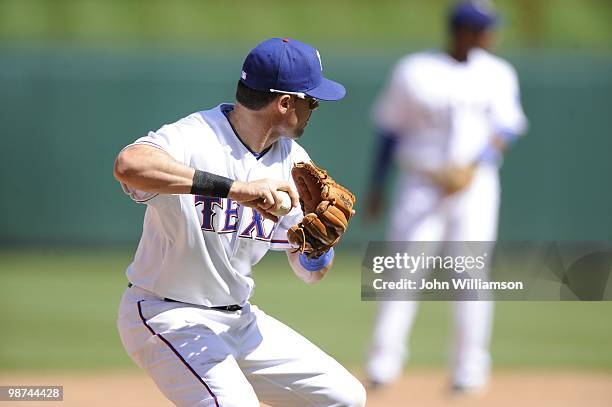 Third baseman Michael Young of the Texas Rangers fields his position as he throws to second base to start a double play after catching as ground ball...