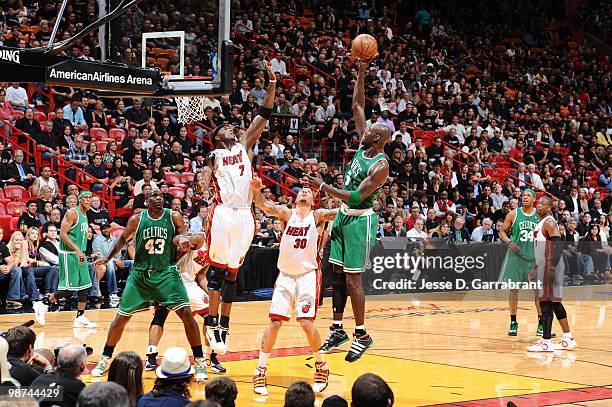 Kevin Garnett of the Boston Celtics shoots over Michael Beasley and Jermain O'Neal of the Miami Heat in Game Three of the Eastern Conference...