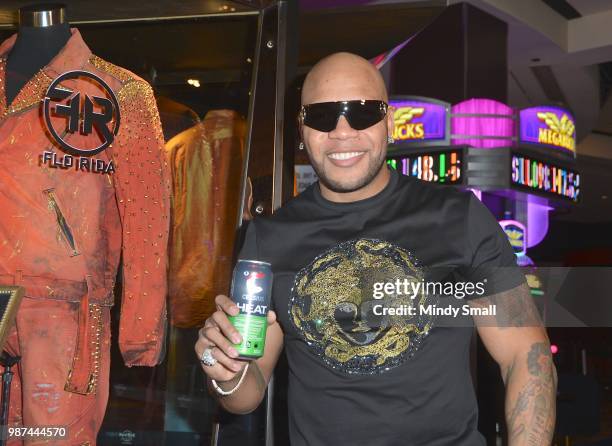 Rapper Flo Rida holds a can of Celsius Heat fitness drink during his memorabilia case dedication at the Hard Rock Hotel & Casino on June 29, 2018 in...
