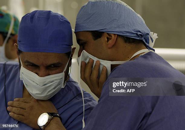 Saudi Health Minister Abdullah al-Rabia talks to an unidentified surgeon during a seven-hour operation to separate two baby boys from Jordan...