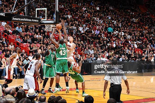 Michael Beasley of the Miami Heat goes up for a shot against Kendrick Perkins of the Boston Celtics in Game Three of the Eastern Conference...