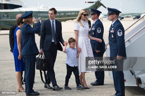 White House Senior Advisers Jared Kushner and Ivanka Trump walk to Air Force One with their children prior to departure from Joint Base Andrews in...
