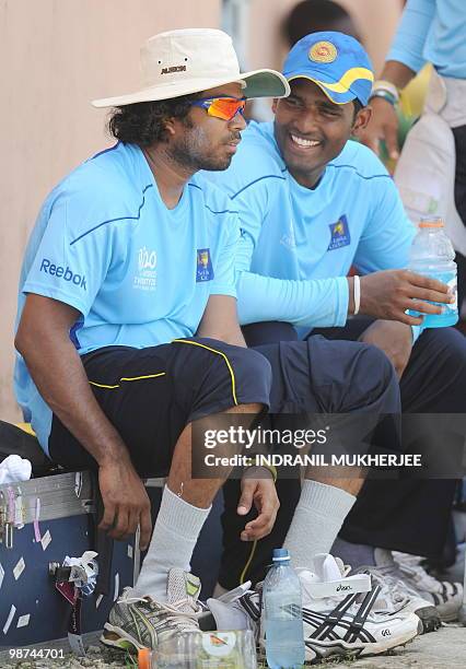 Sri Lankan cricketers Lasith Malinga and Thissara Perera interact during a break in their training session at the Providence Stadium in Guyana on...