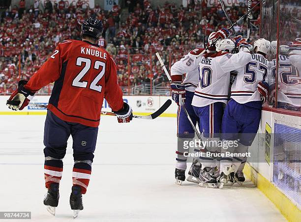 Dominic Moore of the Montreal Canadiens is surrounded by teammates after scoring the game winning goal in the third period against the Washington...